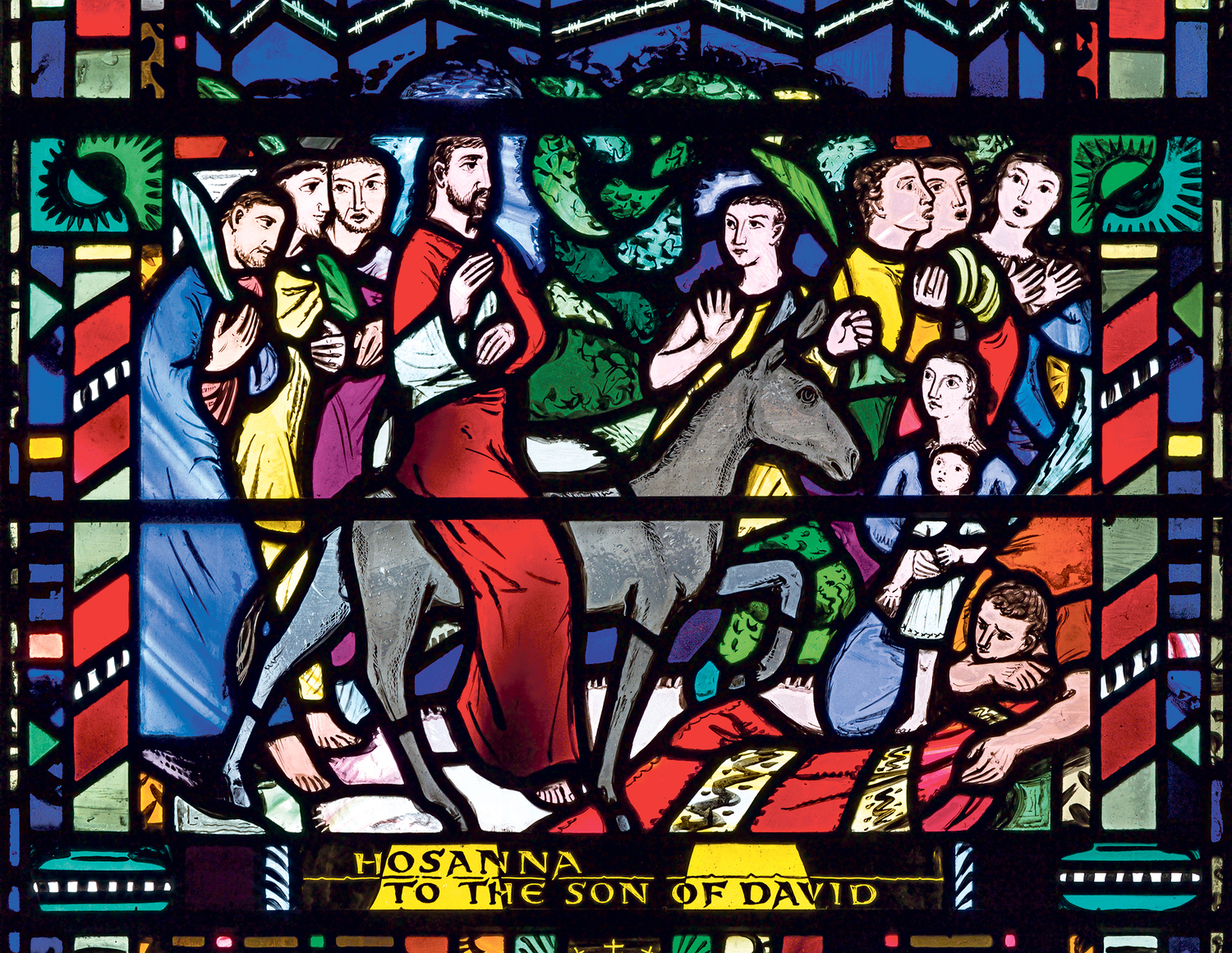 LONDON, GREAT BRITAIN - SEPTEMBER 16, 2017: The stained glass of Palm Sundy - Entry of Jesus in Jerusalem in church St Etheldreda by Charles Blakeman (1953 - 1953).