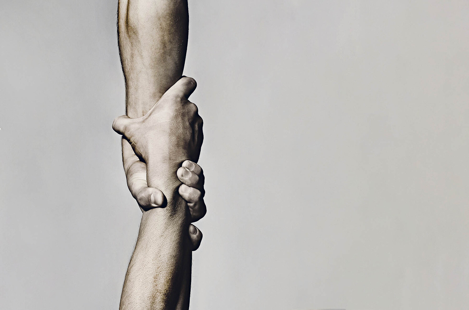 Helping hand concept and international day of peace, support. Helping hand outstretched, isolated arm, salvation. Close up help hand. Two hands, helping arm of a friend, teamwork. Black and white.